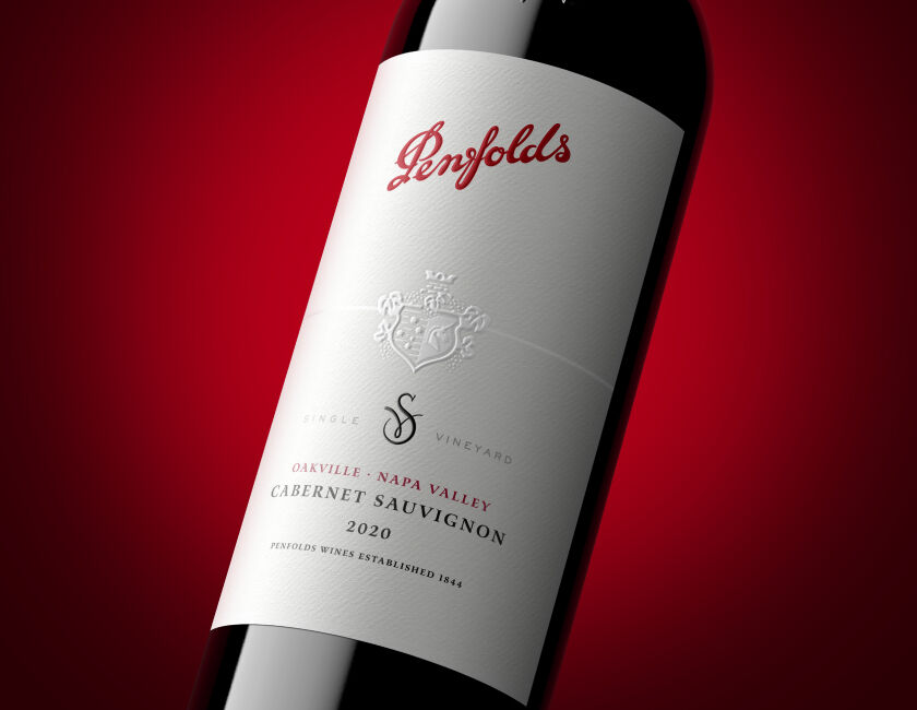 Closeup photograph of Penfolds Oakville Cabernet Sauvignon against red gradient background. 